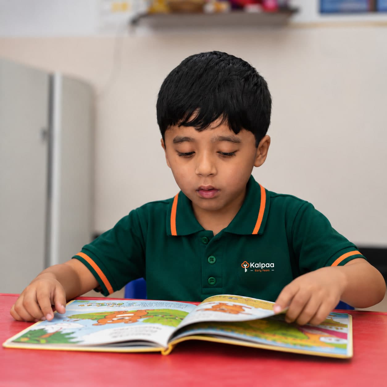 A child absorbed in a picture book